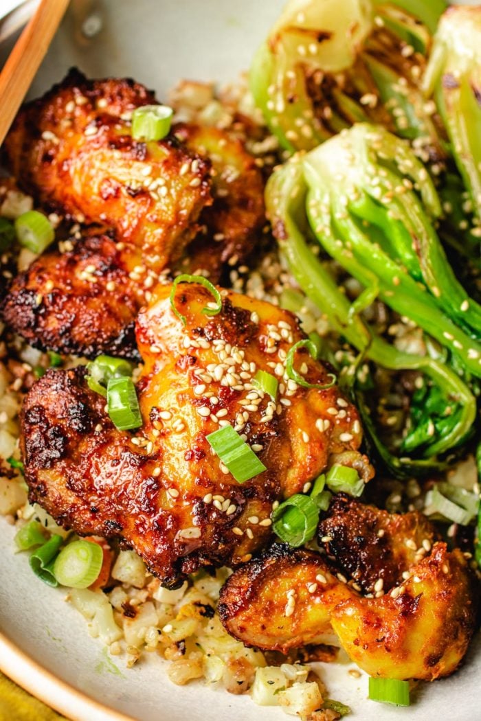 Plated photo shows air fryer satay chicken with cauli rice and bok choy