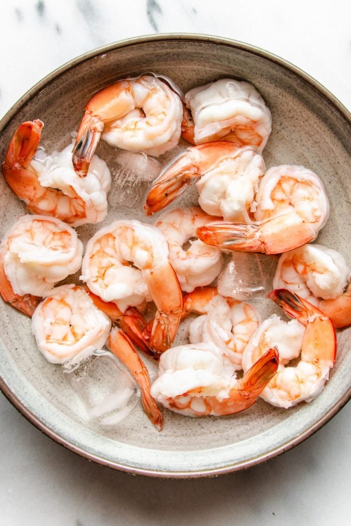A photo of poached shrimp in ice water