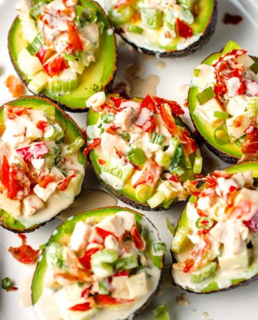Stuffed avocados with chicken and apples over a large plate