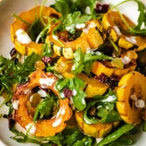 A plate shows baked squash delicata recipe