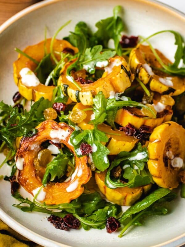 A plate shows baked squash delicata recipe