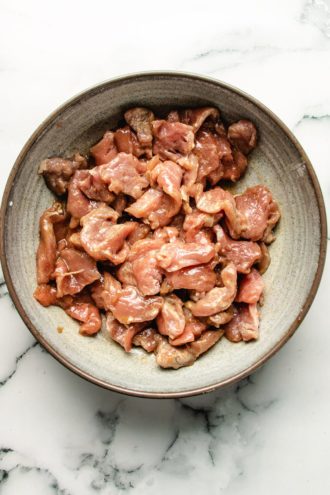 Photo shows the sliced pork in a ginger marinade