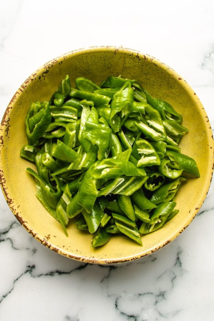 Photo shows sliced peppers prepared in a bowl