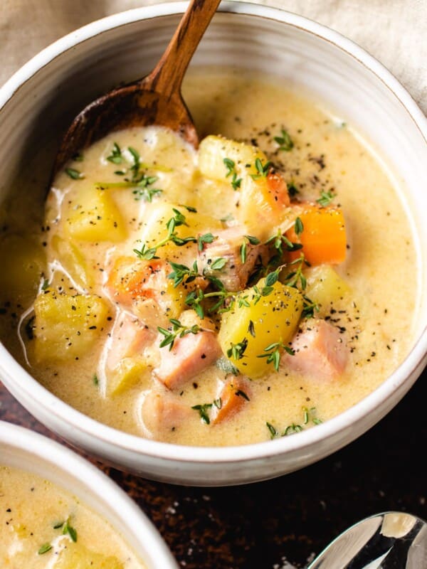 Creamy ham chowder with potatoes in a white bowl