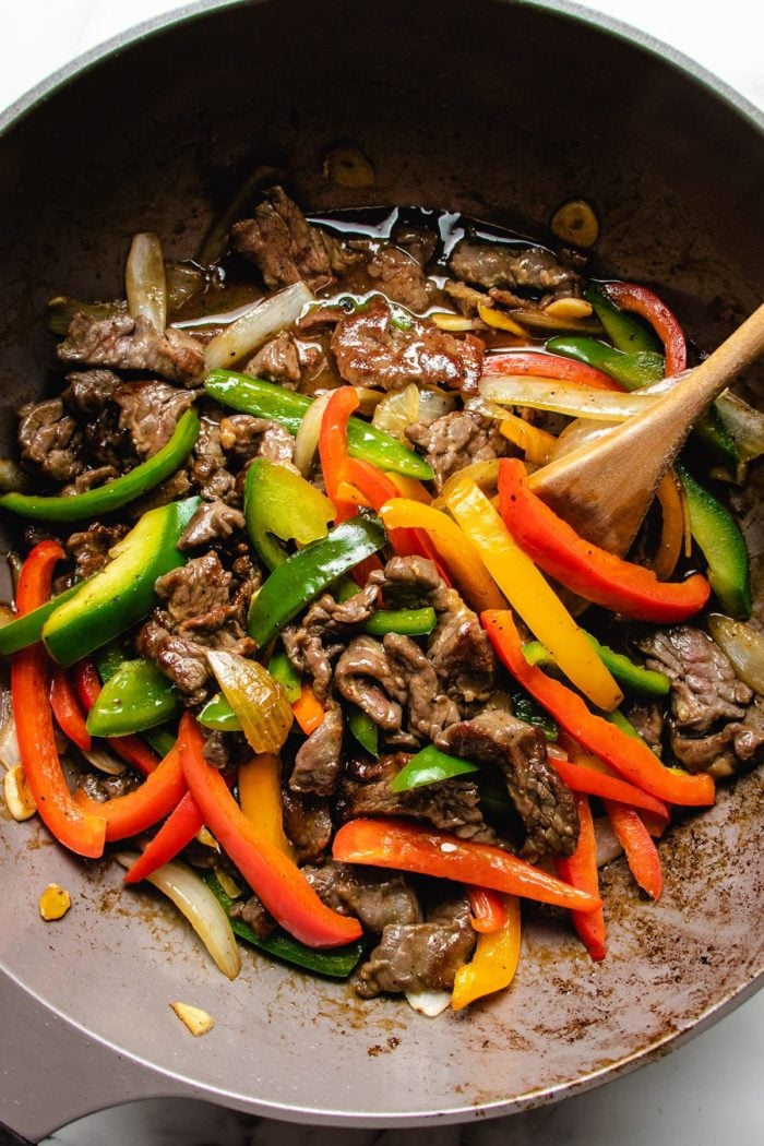 Beef and pepper stir-fry in a wok with extra chow mein sauce