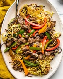 Cantonese beef chow mein feature images served on a large oval plate