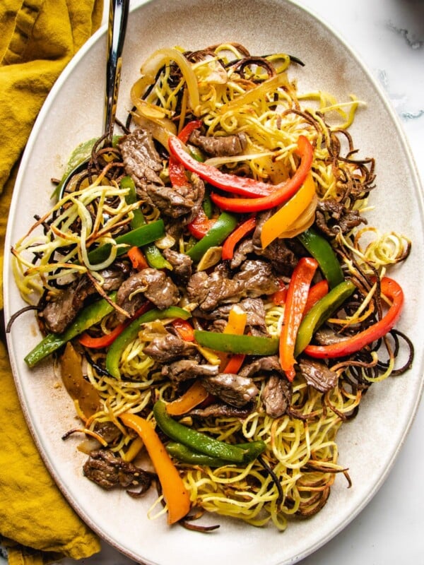 Cantonese beef chow mein feature images served on a large oval plate