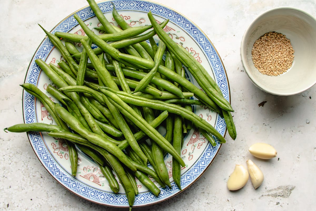 Ingredients with green beans, garlic, and sesame