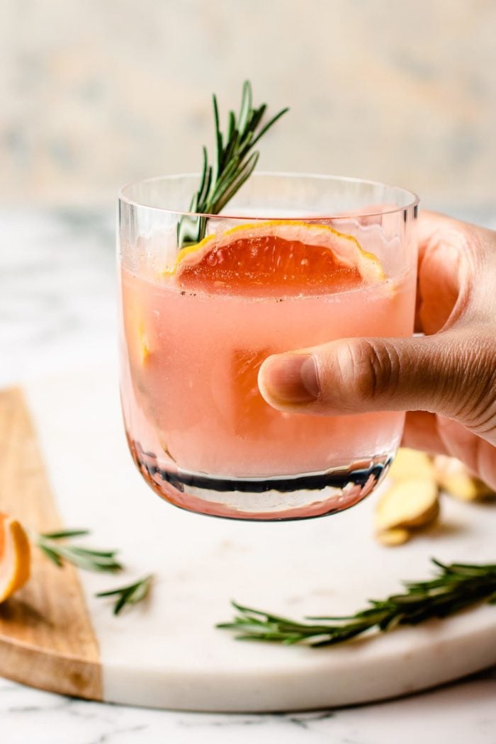 Holding the cocktail glass with drinks