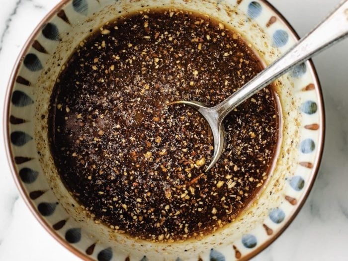 A close shot shows Chinese style black pepper sauce mixed in a small bowl