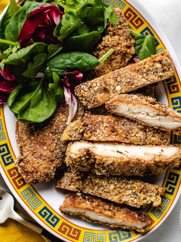 A plate of crunchy Taiwanese fried chicken cut up with salads