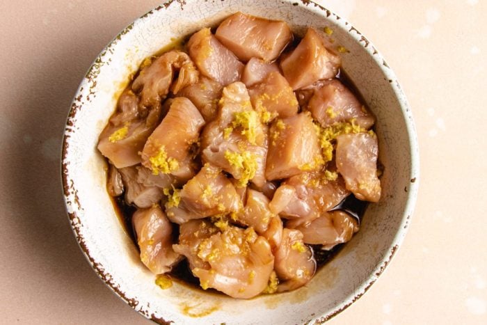 Marinated diced chicken in a white bowl