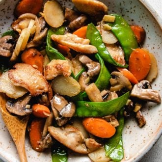 A plate with chicken breast stir-fry with mushrooms and vegetables