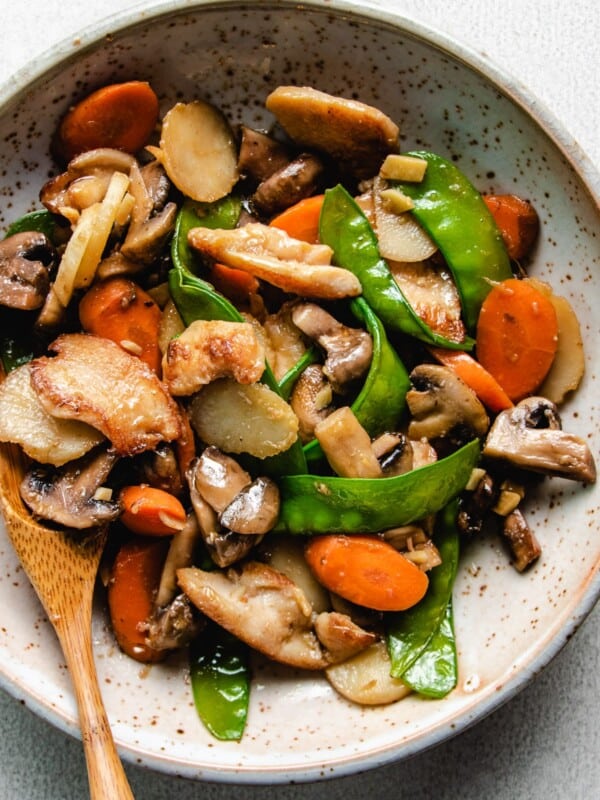 A plate with chicken breast stir-fry with mushrooms and vegetables