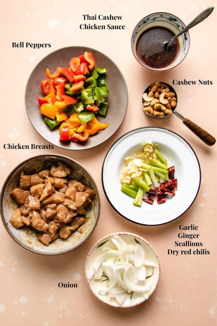 Ingredients to make Thai style cashew chicken stir fry prepared in bowls and plates