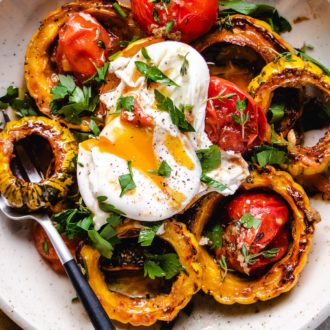 A feature photo shows roasted delicata squash with tomatoes and a poached egg on top over a white plate