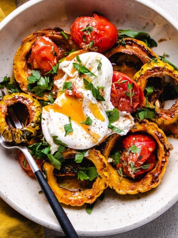 A feature photo shows roasted delicata squash with tomatoes and a poached egg on top over a white plate