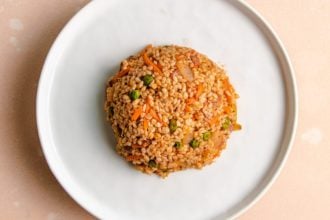 Shirataki fried rice shaped to round shape on a white plate