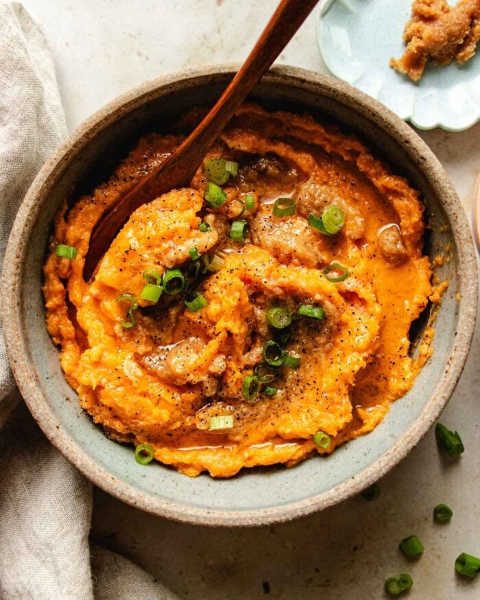 Feature image shows a bowl of miso sweet potatoes blended with butter and served in a bowl.