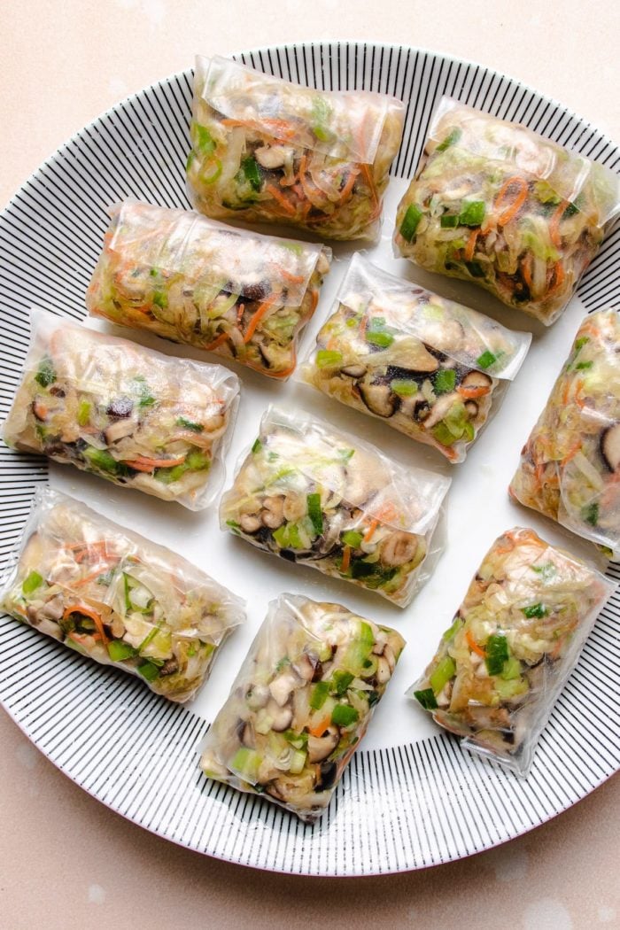 Photo shows rice wrapped dumplings with vegetable fillings inside before frying