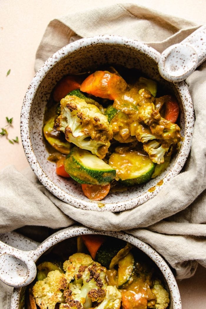 Photo shows two white color soup cups with roasted vegetable curry