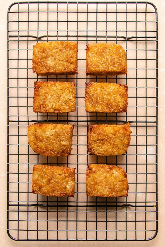 Photo shows 8 pieces of crispy crunchy rice sushi cakes resting on a cooling rack