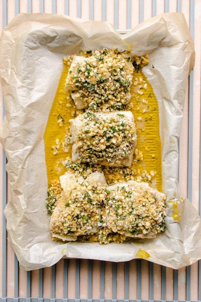 Photo shows cod fillets topped with panko crust before baking