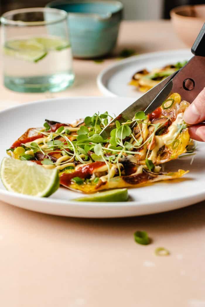 Photo shows how to eat the vietnamese pizza using a kitchen shear to cut it