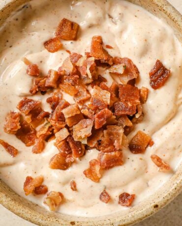 Bacon aioli sauce with creamy texture and crispy bacon bits served in a ceramic bowl