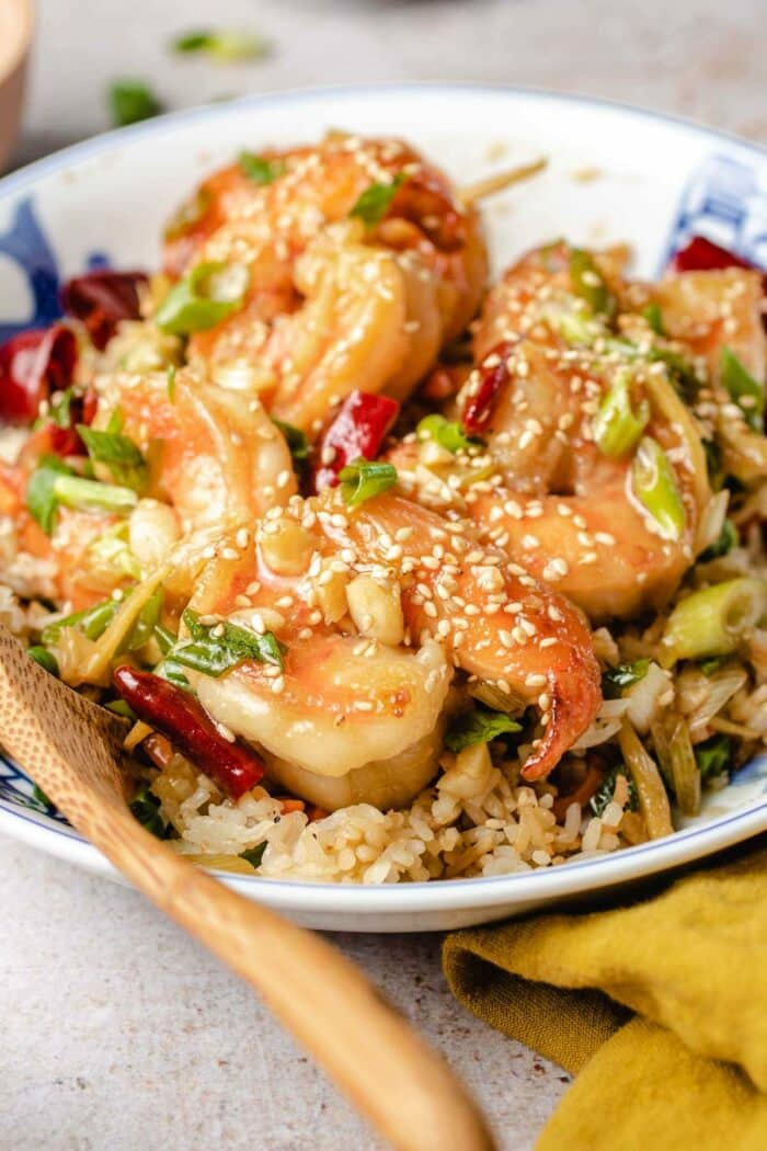 A close shot shows the texture of the shrimp with sticky general tso sauce served over a bed of rice