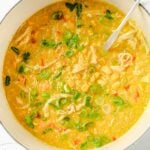 Chicken corn soup recipe in a white color Dutch oven with a soup ladle
