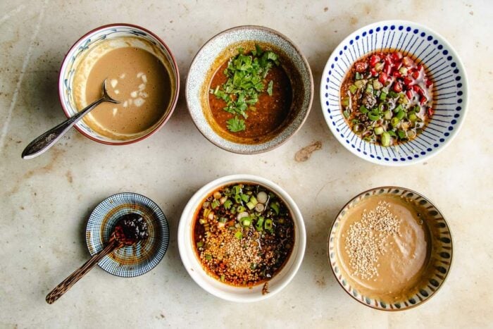 A horizontal feature image shows 5 bowls of different hotpot dipping sauces, plus extra chili garlic sauce on the side