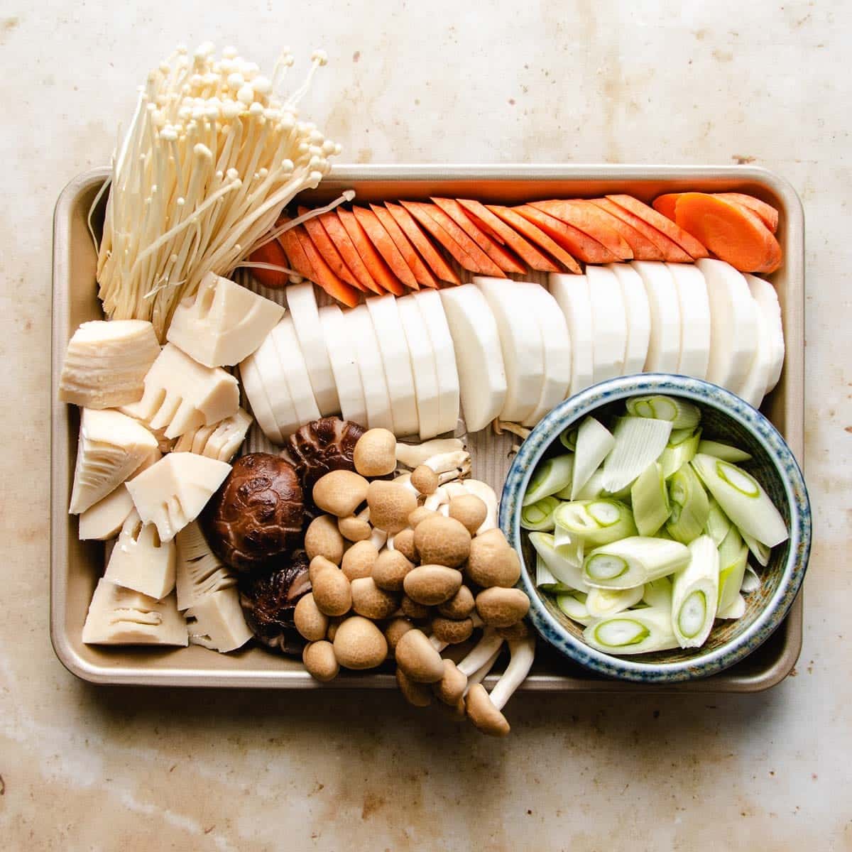 Chopped root vegetables displayed on a sheetpan