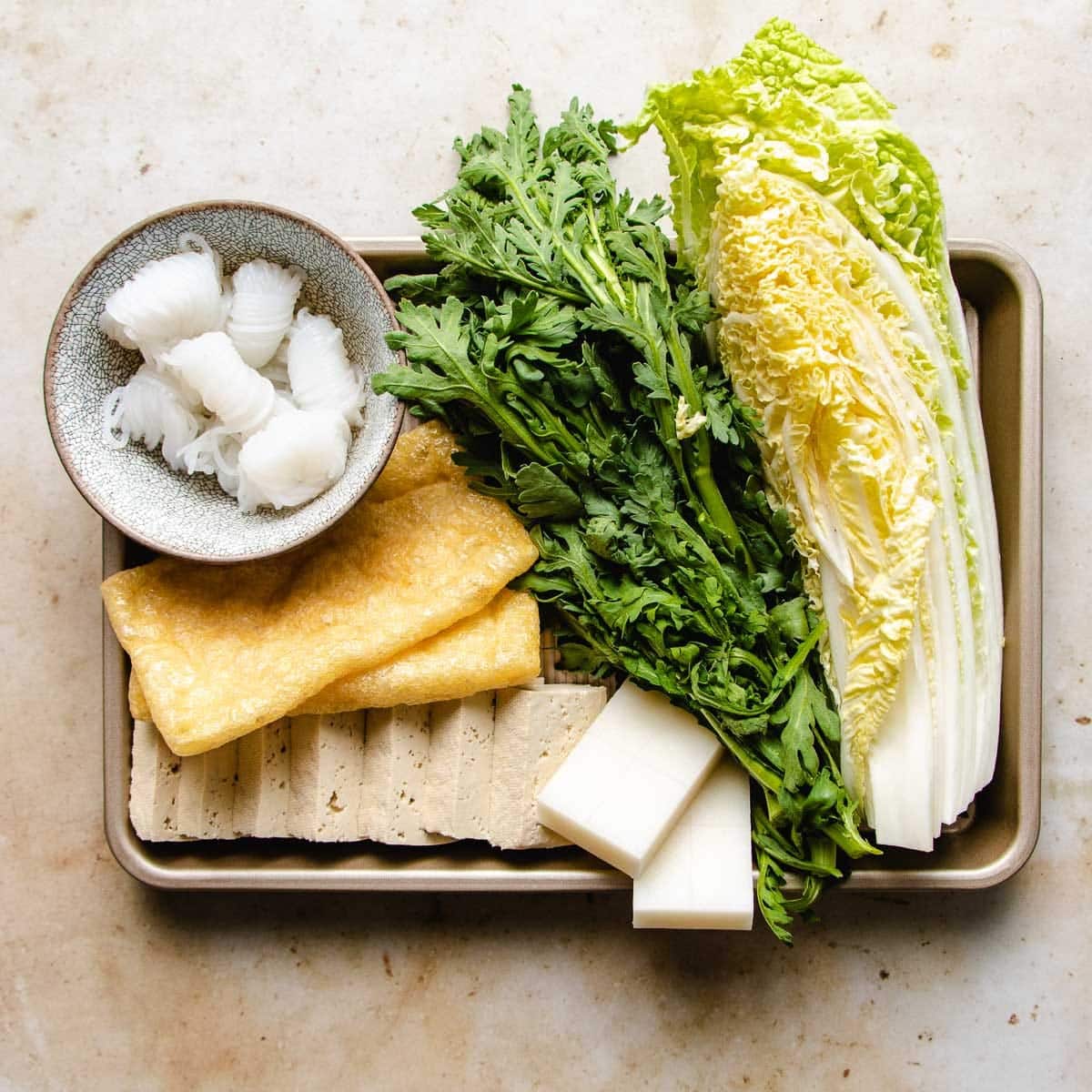 Sliced tofu and vegetables prepared on a sheetpan