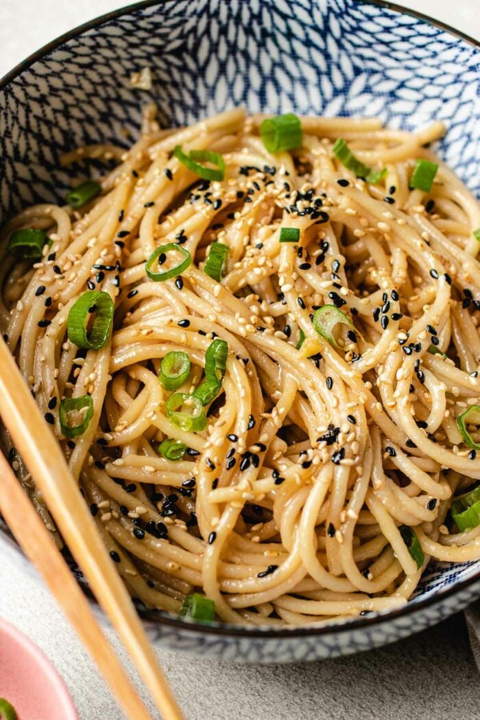 A close side shot shows spaghetti noodles hibachi style served in a blue white color bowl