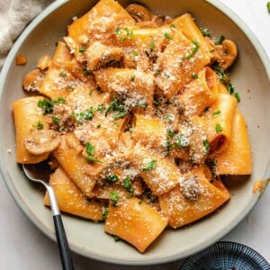 Pasta gochujang recipe with gluten-free pasta noodles served in a light gray color plate with a fork on the side.