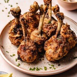 Photo shows chicken lollipop recipe made from chicken drumsticks and served on a plate.