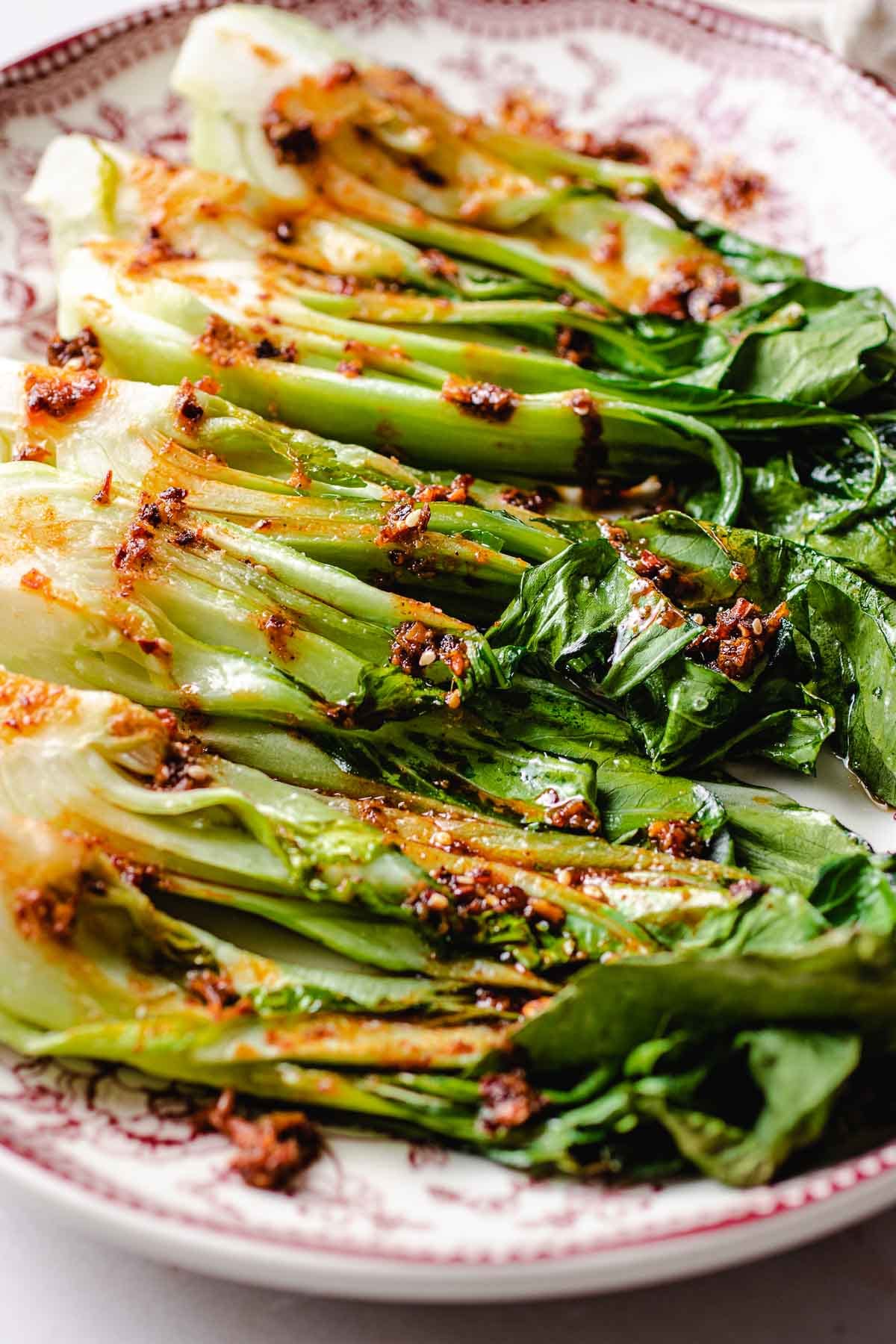 A side close shot shows bok choy roasted and served on a big platter