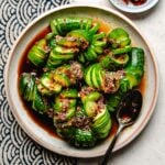 Recipe image for Chinese style spicy cucumber salad served with chili garlic dressing on a plate