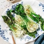 A recipe image shows air fried bok choy with sesame garnish served on a blue white color plate