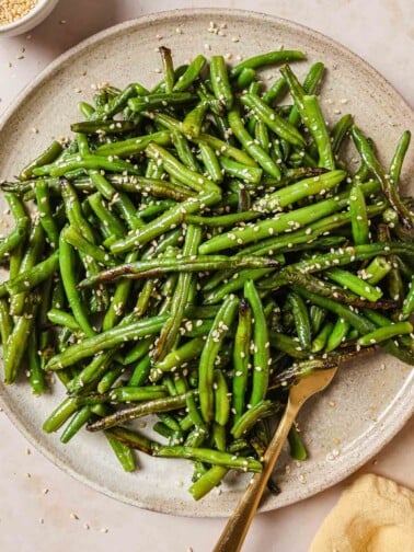 Photo shows air fried frozen green beans that are perfectly crisp and tender served on a neutral color plate