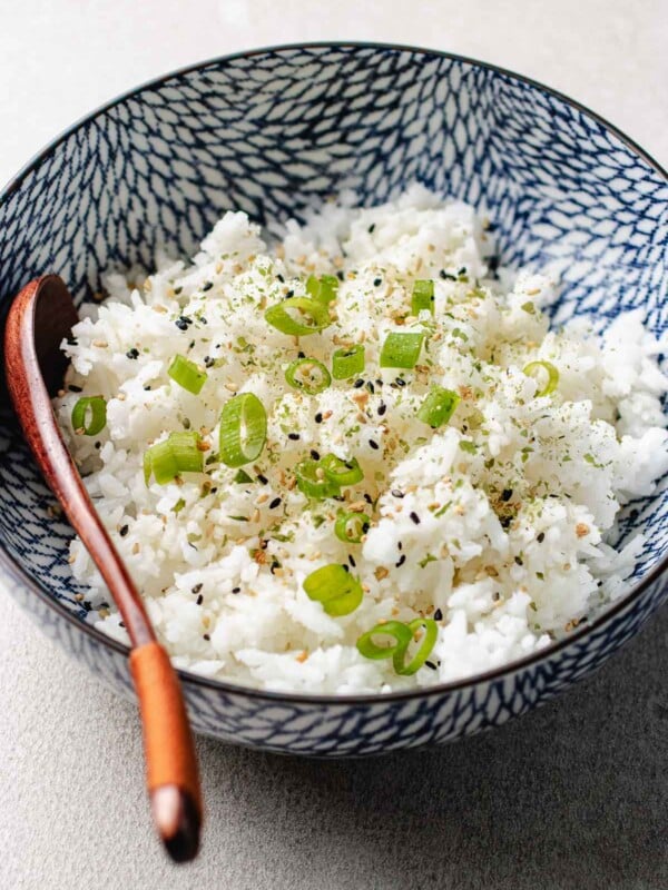 Photo shows rice grains cooked to perfection in an air fryer and served in a blue white color bowl