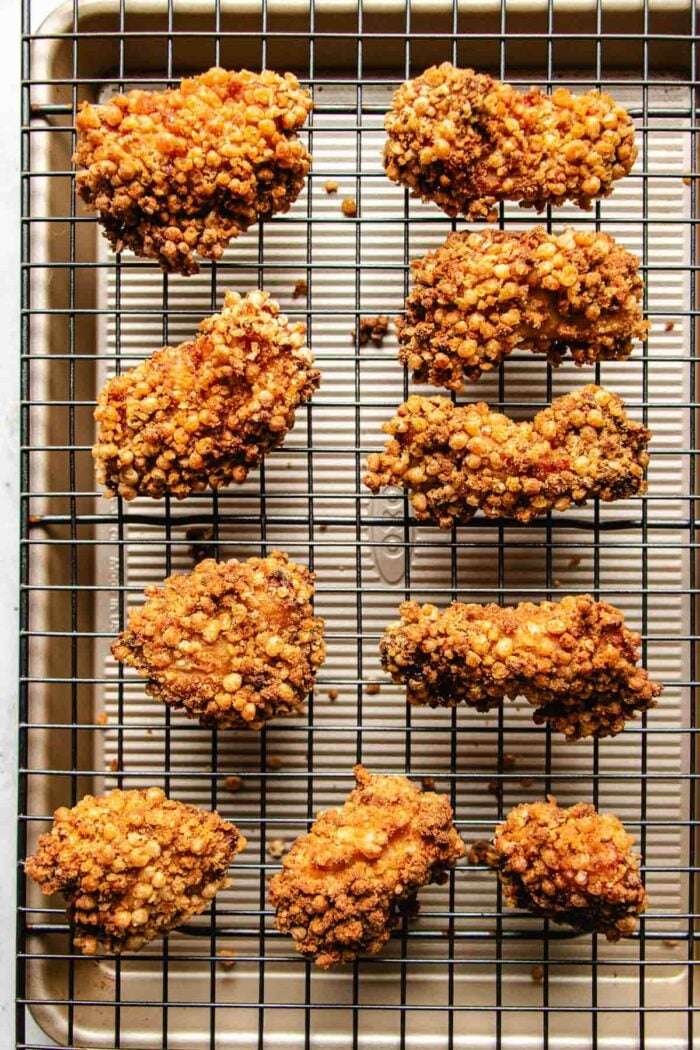 A close shot shows Panda Express copycat Crispy almond chicken displayed on a cooling rack.