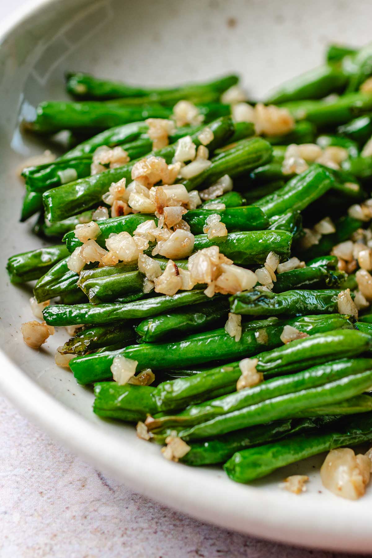 A side close shot photo shows the perfect blistered string beans with loads of minced garlic on top just like the restaraunts.