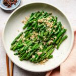 Image for Din tai fung green beans recipe made in an air fryer with minced garlic on top.
