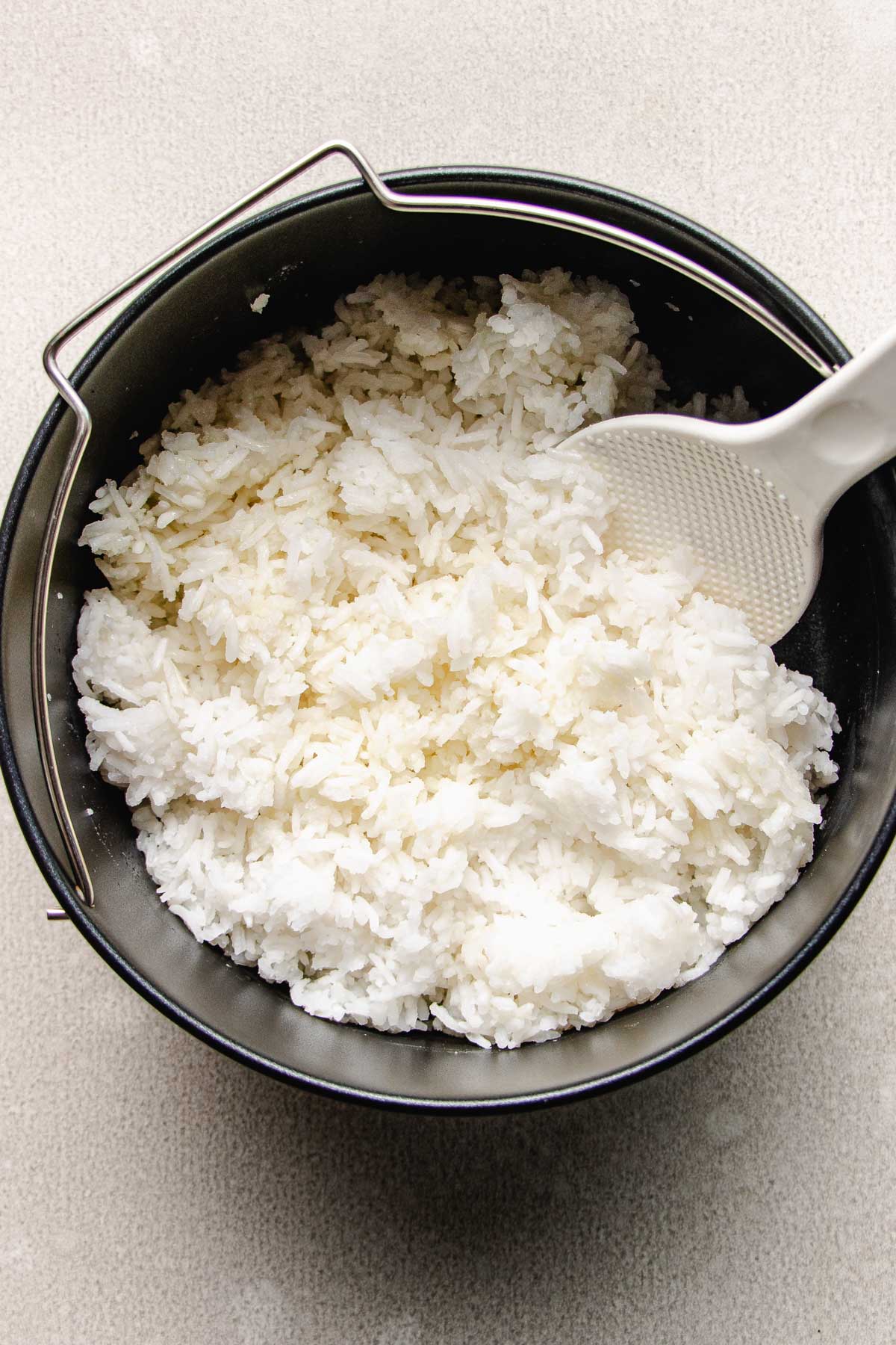 Image shows perfectly cooked white rice in a cake pan made in an air fryer