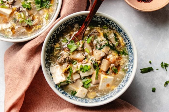 Chinese minced beef soup with tofu and shiitake served in a soup bowl