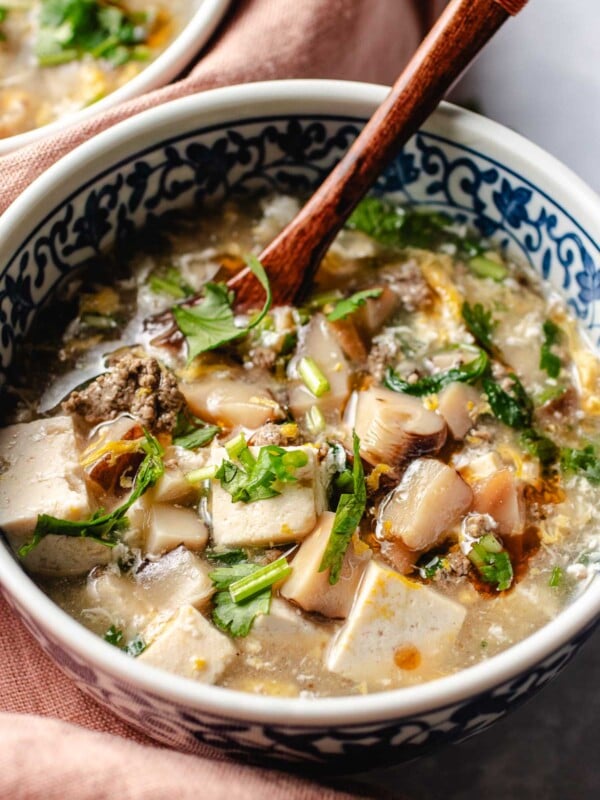 Photo shows West lake beef soup served in a Chinese style blue and white color soup bowl