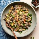 Recipe image shows cubed steak and rice grains stir fried with vegetables on a plate.