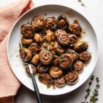 A recipe image shows steak house mushrooms served whole with thyme garnish on top.